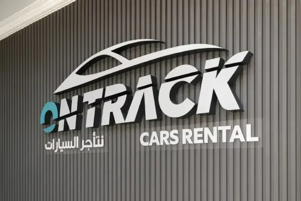 Full indoor signage solution including dimensional wall strips and 3D frontlit reception sign for car rental office brand environment in Abu Dhabi