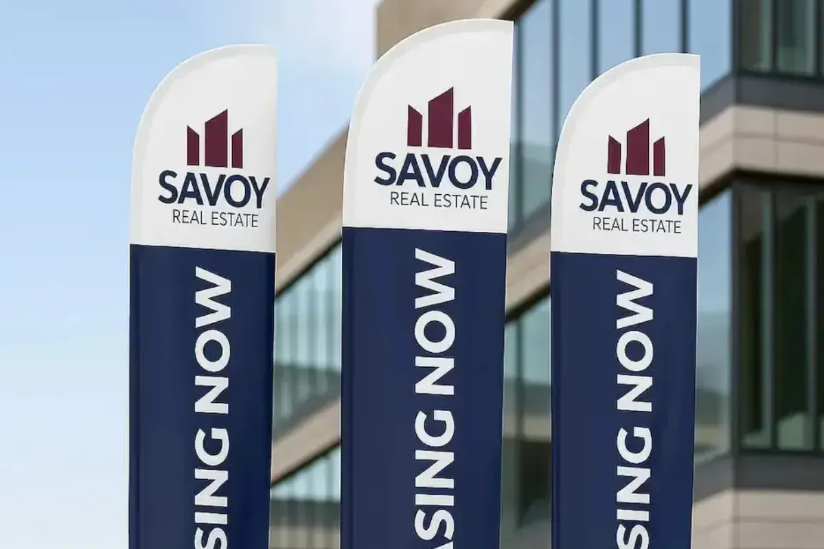 Premium 4-meter height double-sided feather flags with satin, blackout liner, and concrete painted square bases for Abu Dhabi property marketing.