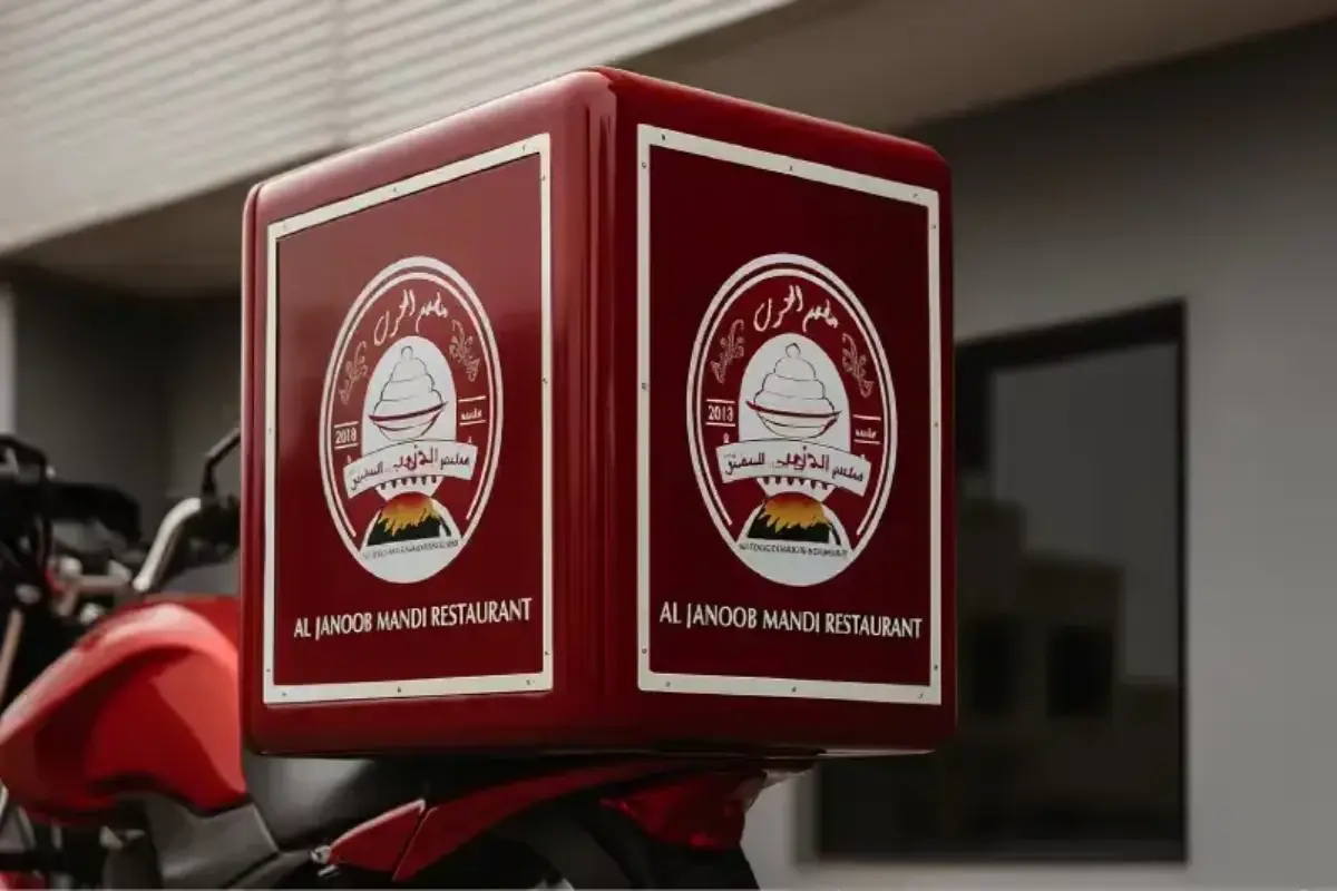 Delivery bike box branding with safety-reflective stickers ensuring compliance with DED vehicle advertisement permit requirements for restaurant food delivery operations.