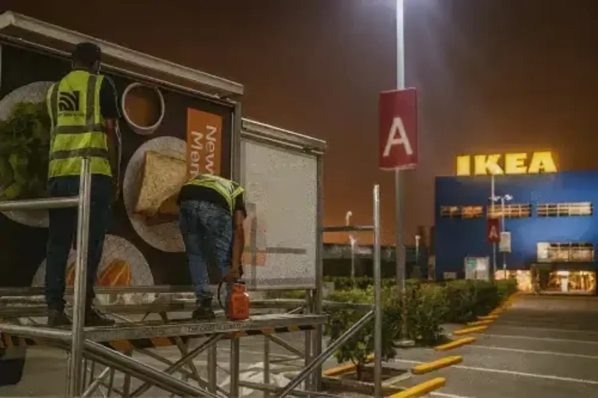 Outdoor billboard campaign branding with night-shift installation after working hours for Dubai retail advertising promotion throughout city high-traffic locations.