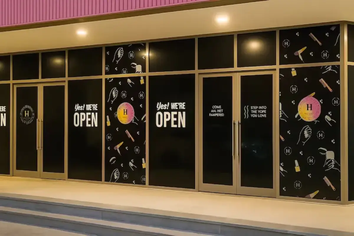 Blackout printed window graphics with business information and brand patterns for Abu Dhabi beauty salon providing privacy and promotional storefront display.