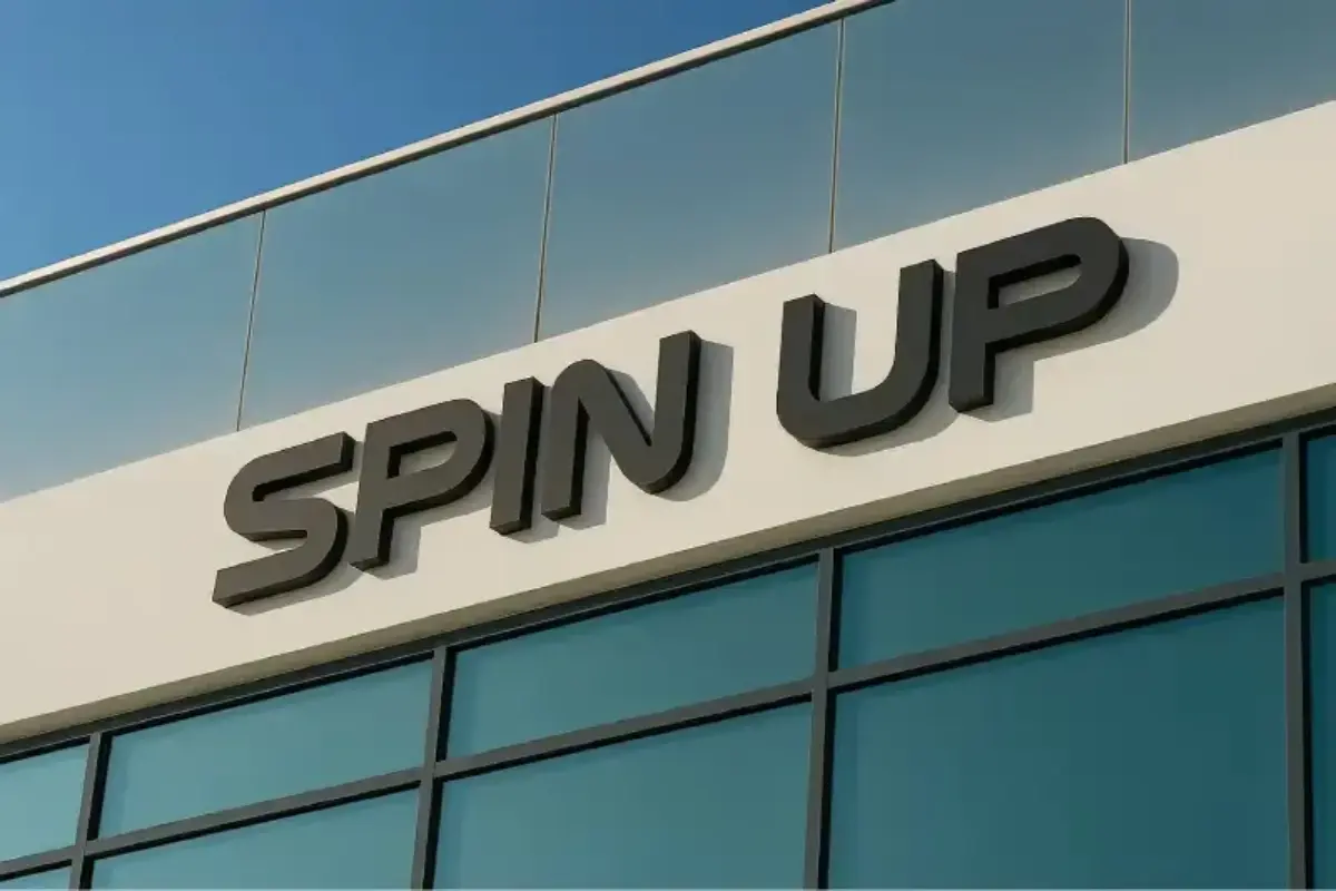 Powder-coated aluminum 3D letters with halo LED effect mounted using aluminum spacers creating light-leak gap against existing wall in Abu Dhabi.