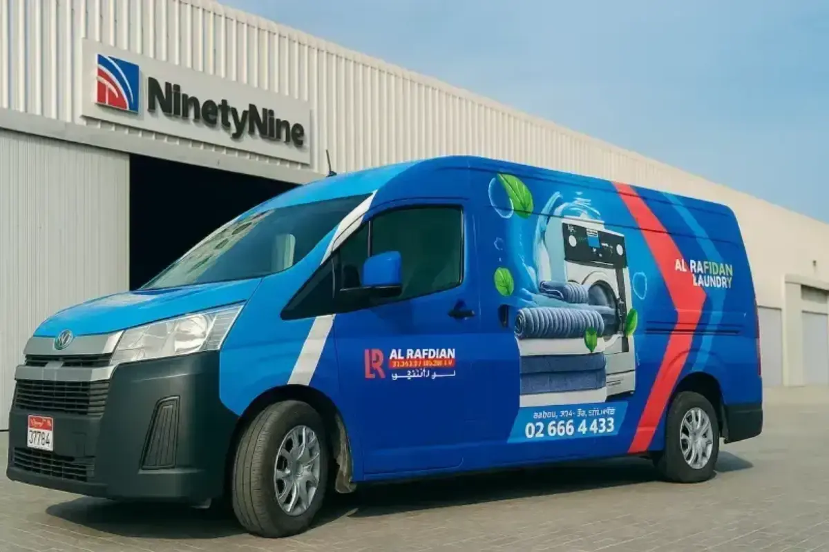 Full wrap branding of high-roof Toyota delivery van for laundry pickup and delivery service fleet operations across Abu Dhabi service territories