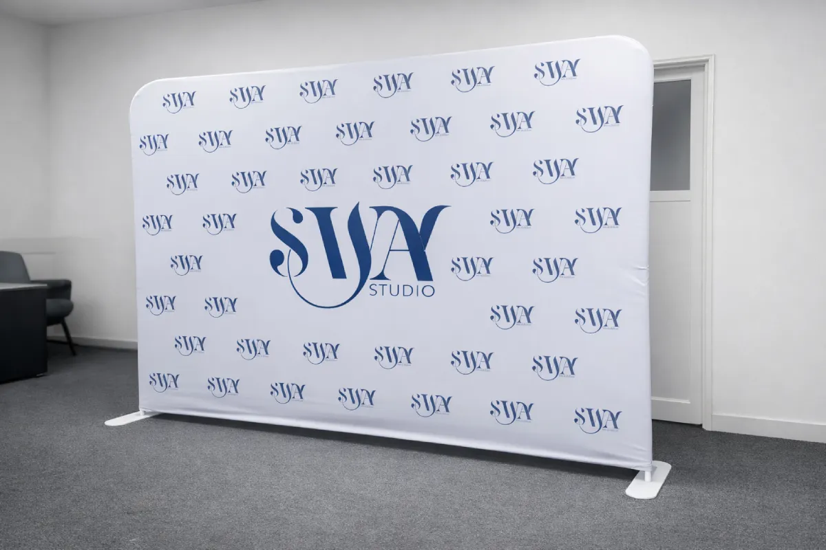 Tension fabric banner with logo pattern delivering branded backdrop for ladies wellness studio interior and event photography.