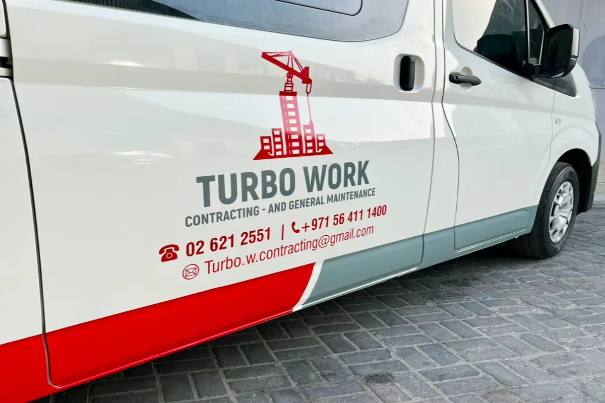 Turbo Work Contracting Cut Vinyl Fleet Decals with red logo graphics on a white van in Al Khaldiya, Abu Dhabi by Ninety Nine Advertising LLC.