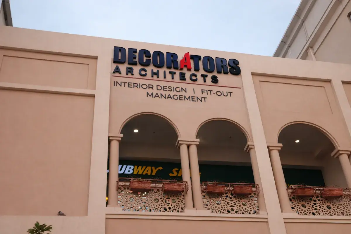 Decorators Architects halo-backlit 3D channel letters on building facade in Al Seef, Abu Dhabi.