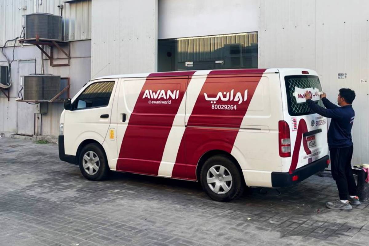 Awani Red Stripe Partial Vehicle Branding on a delivery van on Muroor St, Abu Dhabi by Ninety Nine Advertising LLC.