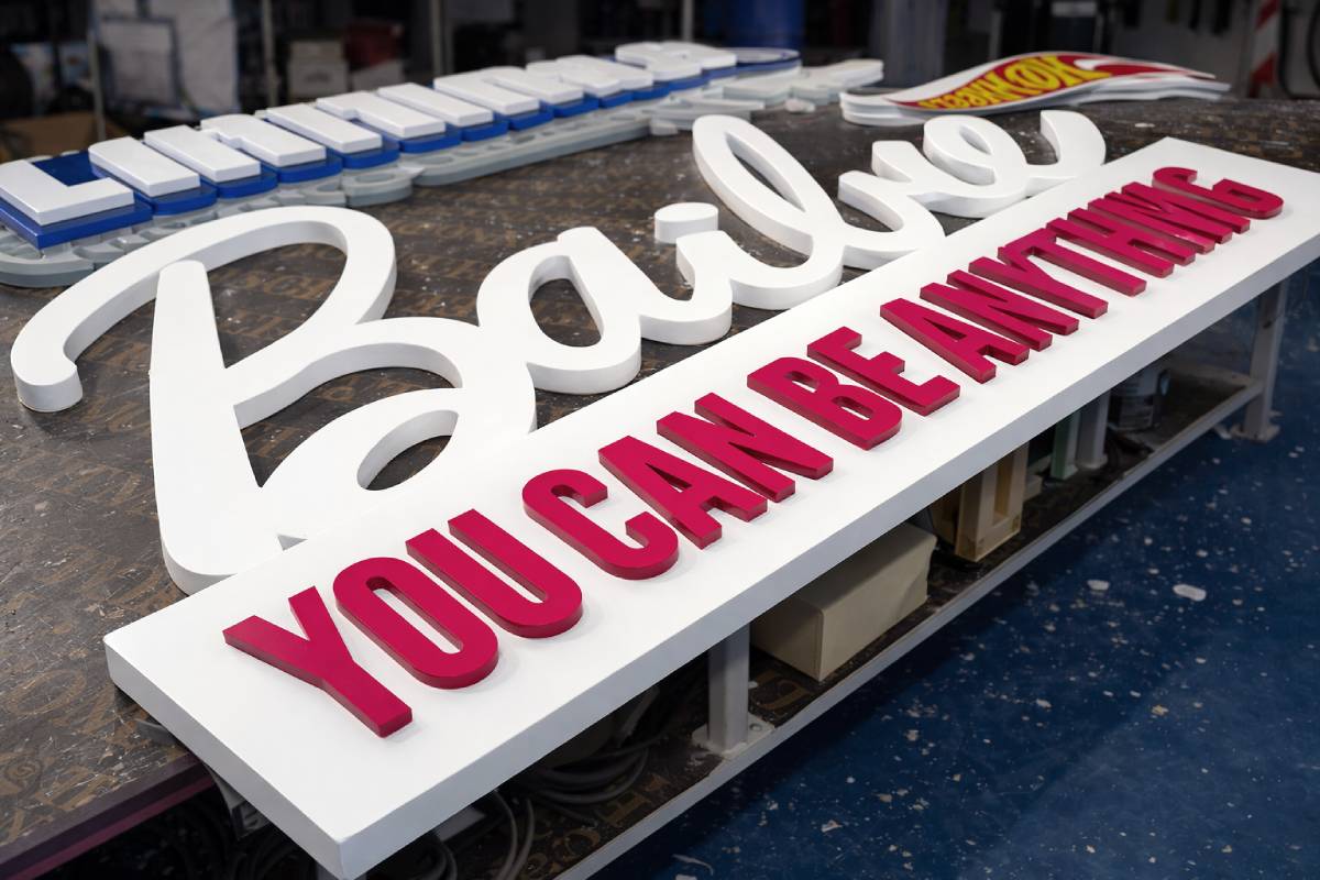 top side view shot Barbie pink white script logo Freestanding 3D Letters retail event display fabrication Al Reem Island Abu Dhabi Ninety Nine Advertising LLC