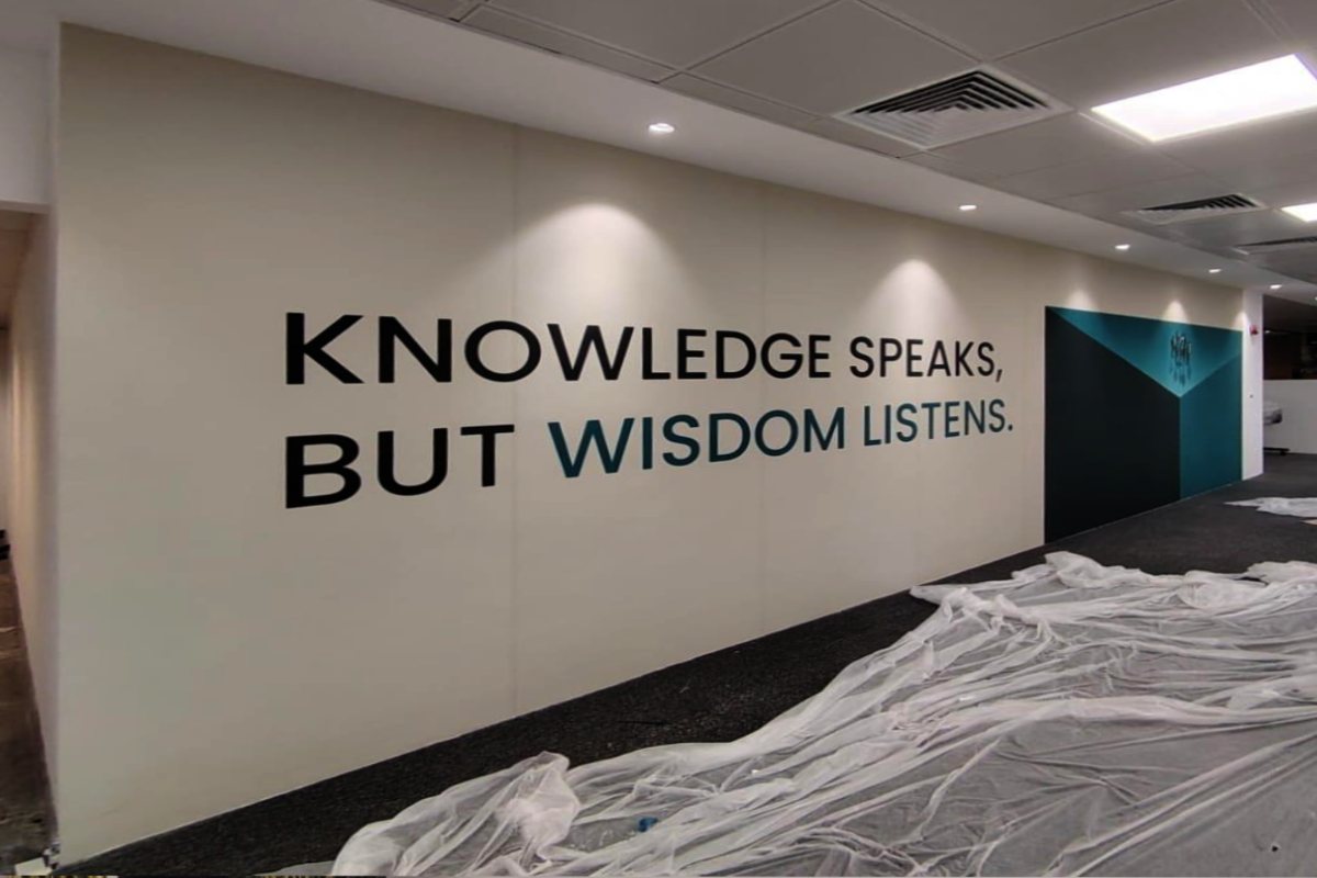 textured-custom-printed-wallpaper-with-corporate-typography-branding-knowledge-speaks-wisdom-listens