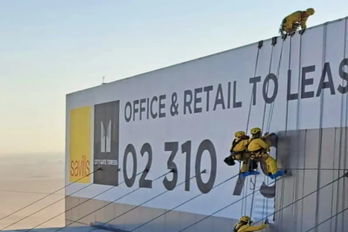 Close up side view of Outdoor Banner installation for Savills using rope access