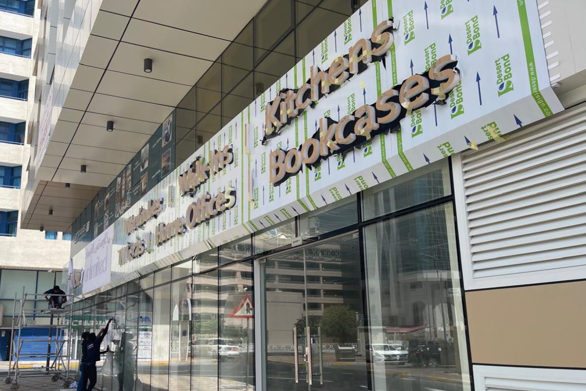Ninety Nine Advertising LLC installing storefront signboard for Closets Unlimited in Abu Dhabi