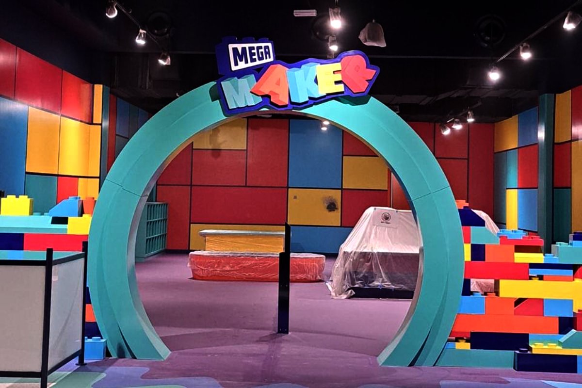 MEGA Maker entrance signage and themed environmental branding at Mission Play by Mattel