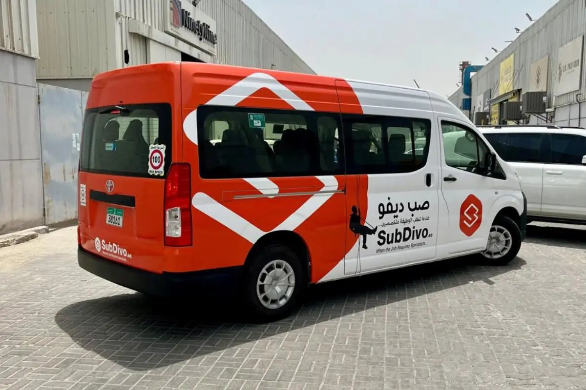 SubDivo partial branding on an orange Toyota HiAce in Abu Dhabi