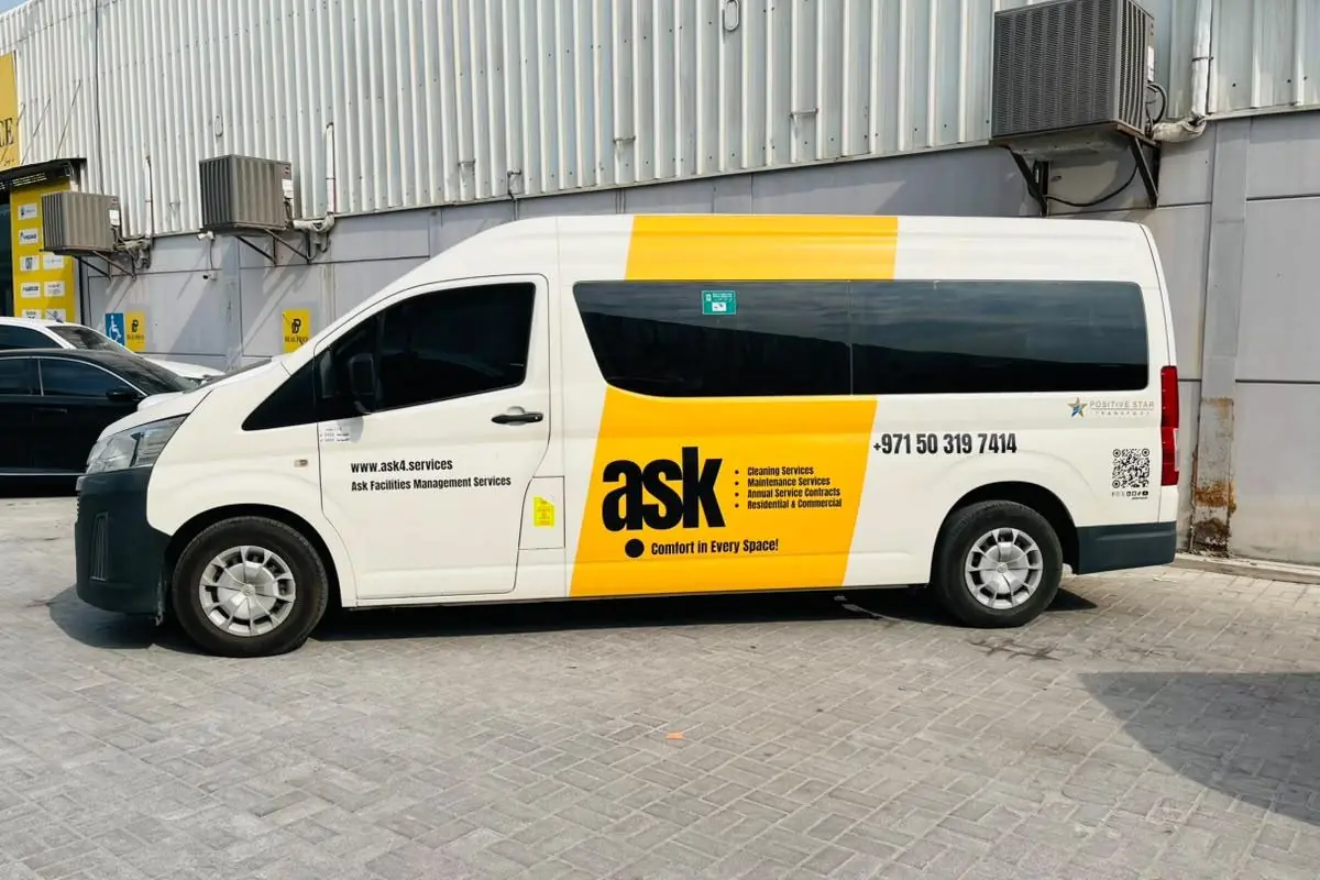 Partial branding with yellow panels on a white van in Abu Dhabi