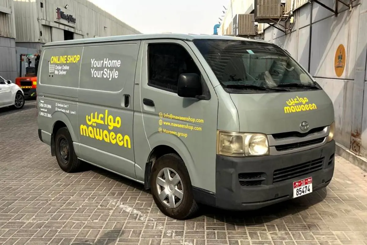 Mawaeen full vehicle branding on a grey Toyota HiAce in Abu Dhabi