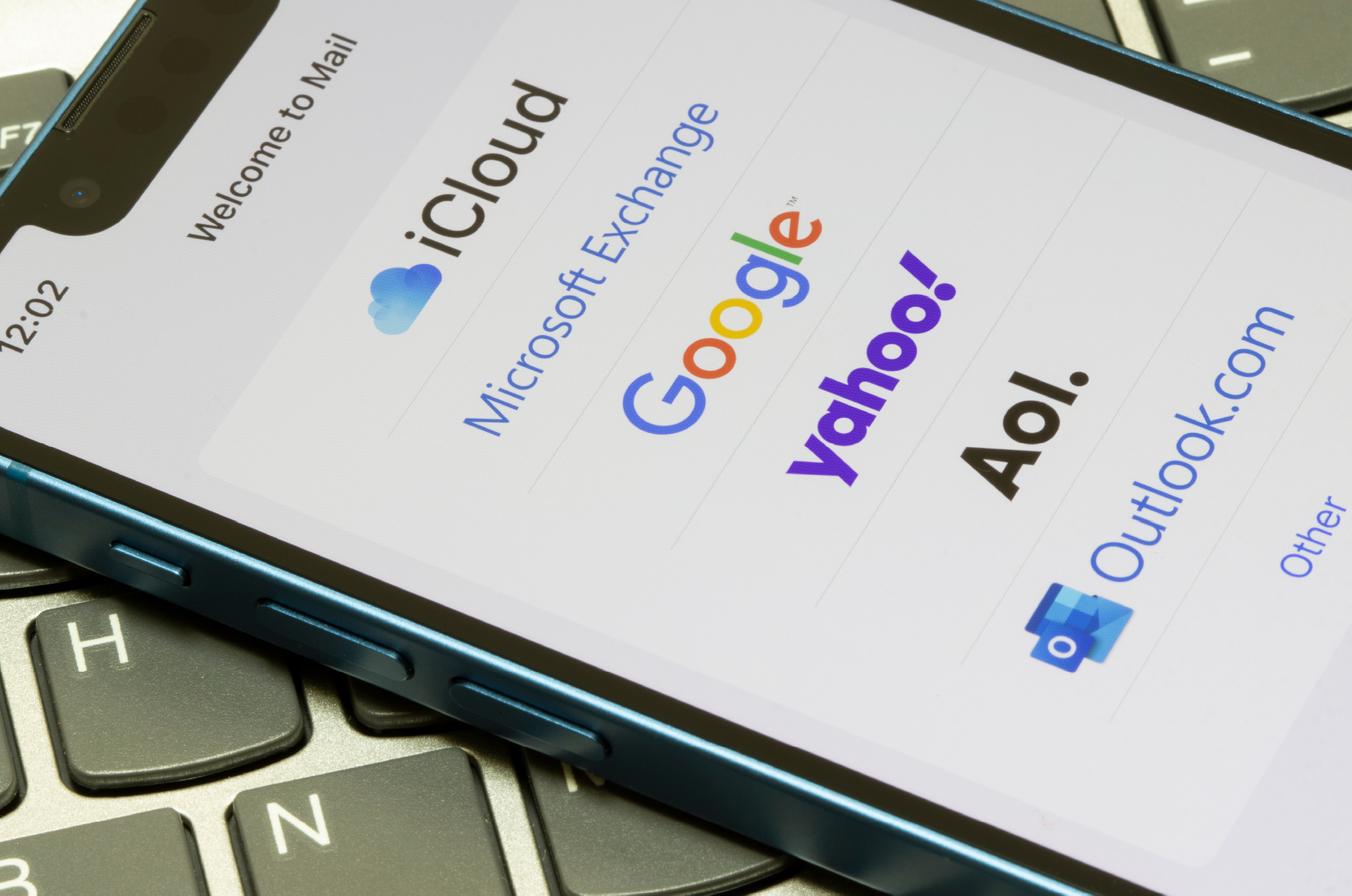 A phone with a list of email providers' logos
