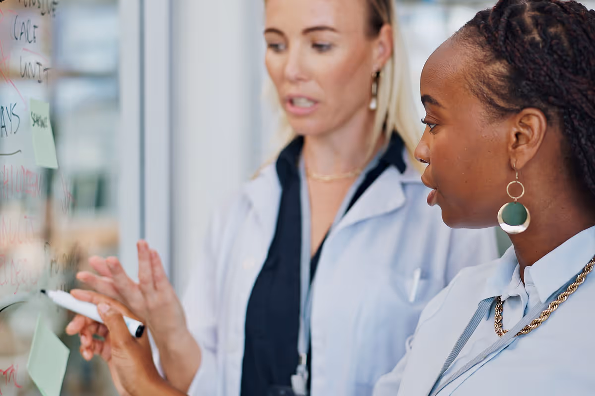 Healthcare executives discussing synergy post-merger