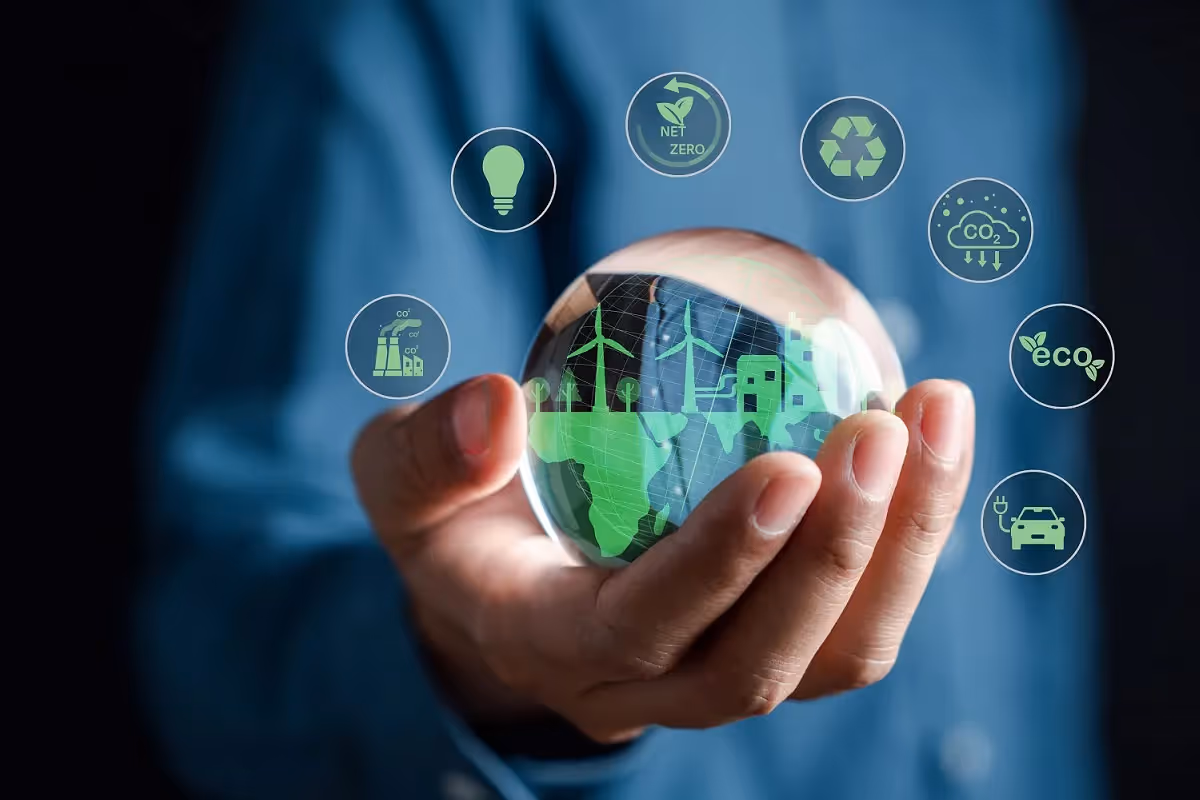 Hand holding a globe surrounded by icons