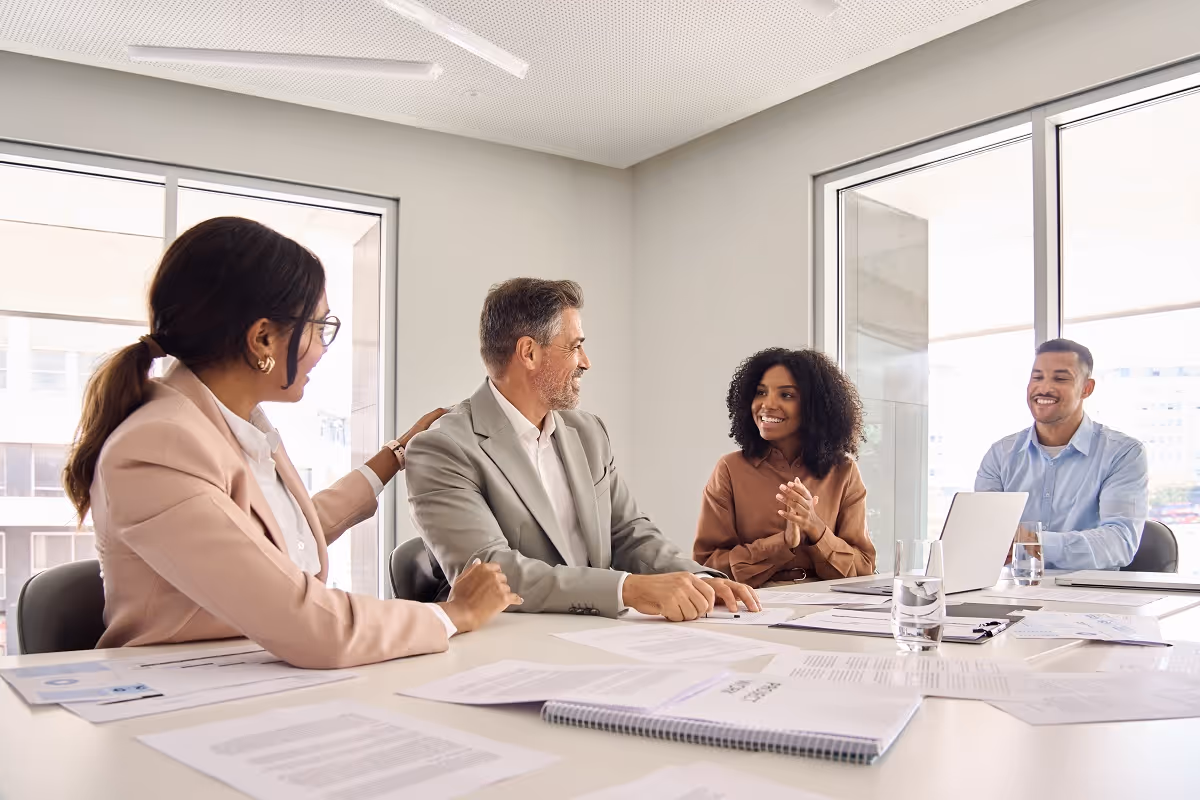 Diverse group of business professionals discussing corporate roll-up strategy in a modern conference room