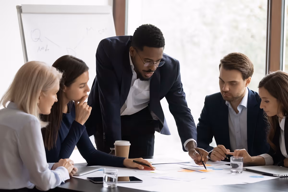 Investment banking team analyzing due-diligence documents and financial models for a potential acquisition
