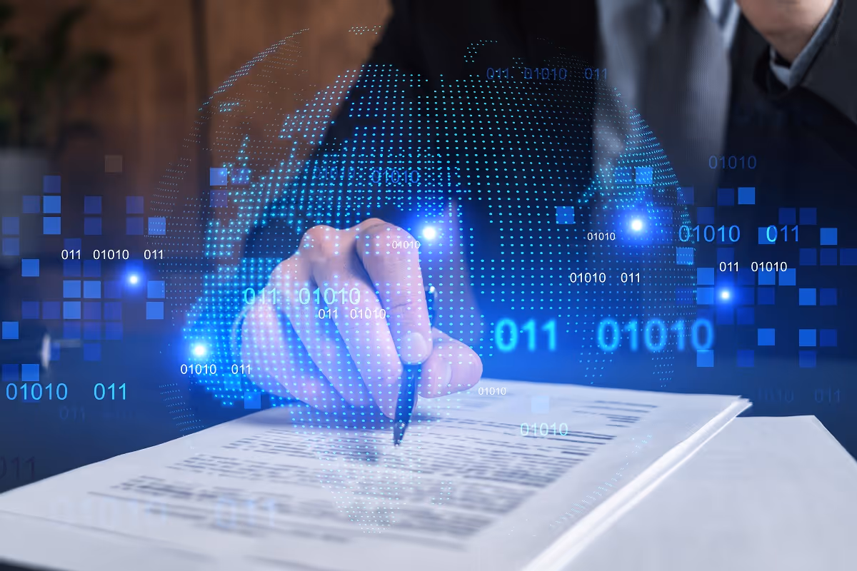 Businessperson signing a contract document with a digital overlay of binary data and a glowing globe, symbolizing technology-driven commercial due diligence in M&A transactions