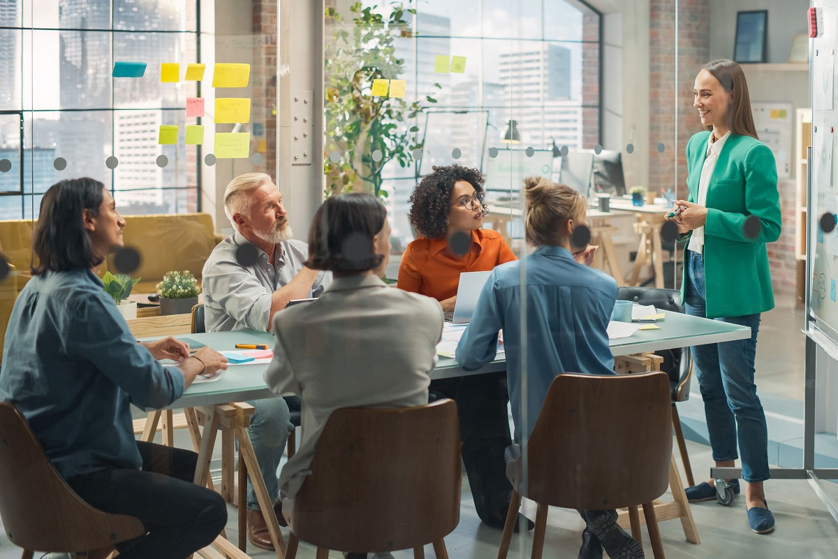 Private equity partners and analysts collaborating on portfolio strategy and value creation initiatives during a team meeting