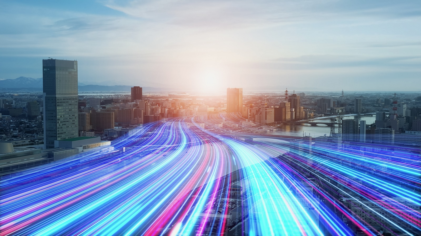 Digital data streams flowing through a city skyline, representing technology-driven markets and economic growth