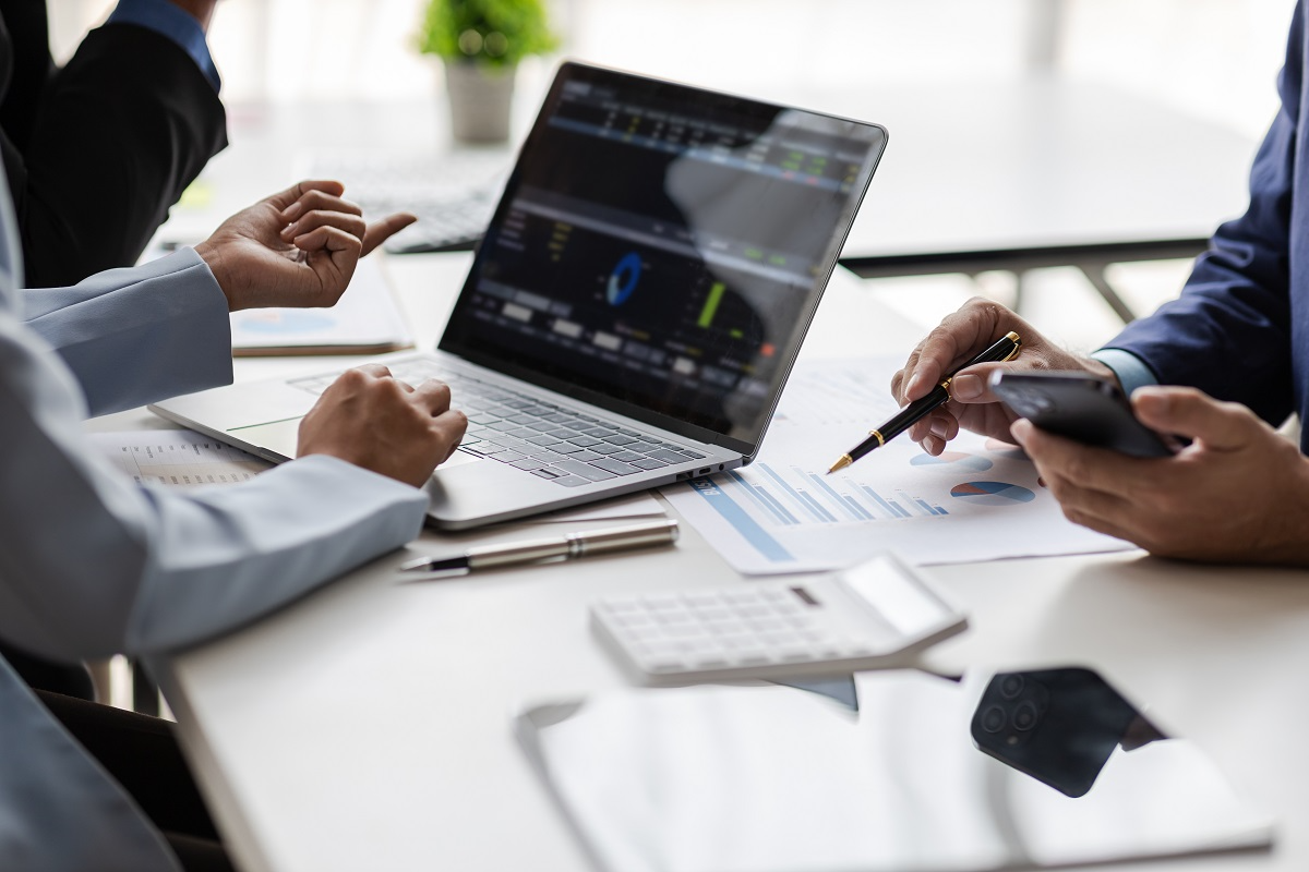 M&A deal team reviewing financial statements and due diligence data during acquisition analysis