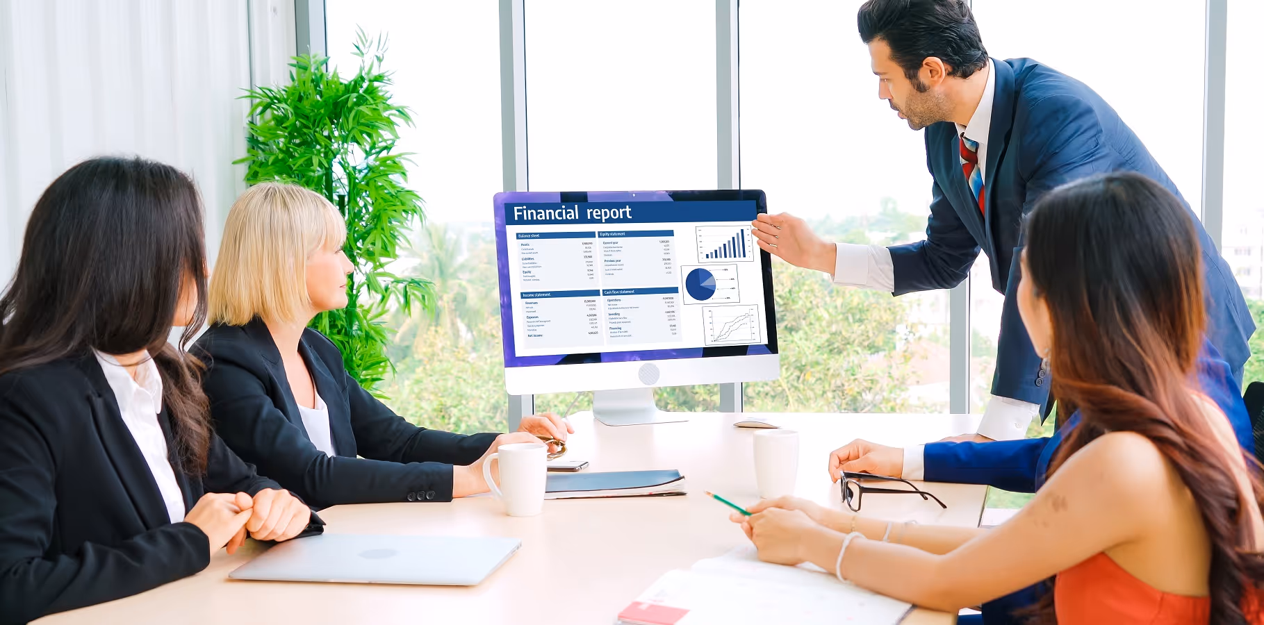 M&A advisory team reviewing a financial report and performance metrics during financial due diligence meeting