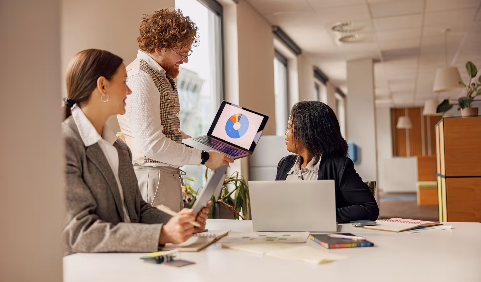 Business team reviewing risk assessment metrics and compliance findings during a legal vendor due diligence meeting
