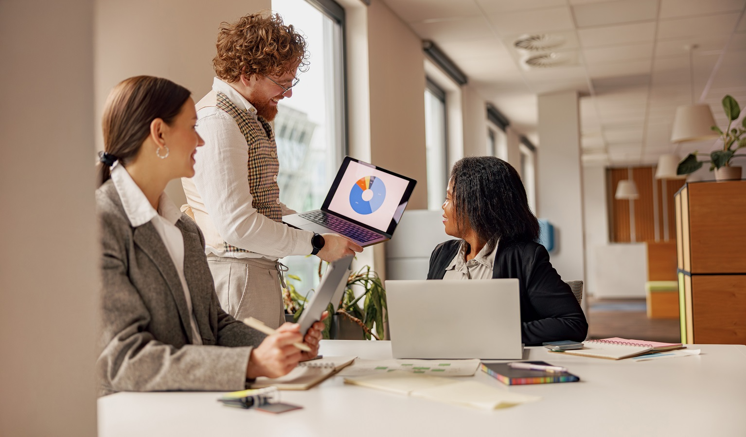 Business team reviewing risk assessment metrics and compliance findings during a legal vendor due diligence meeting