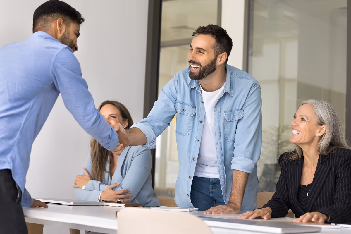 Business leaders shaking hands to close acquisition deal