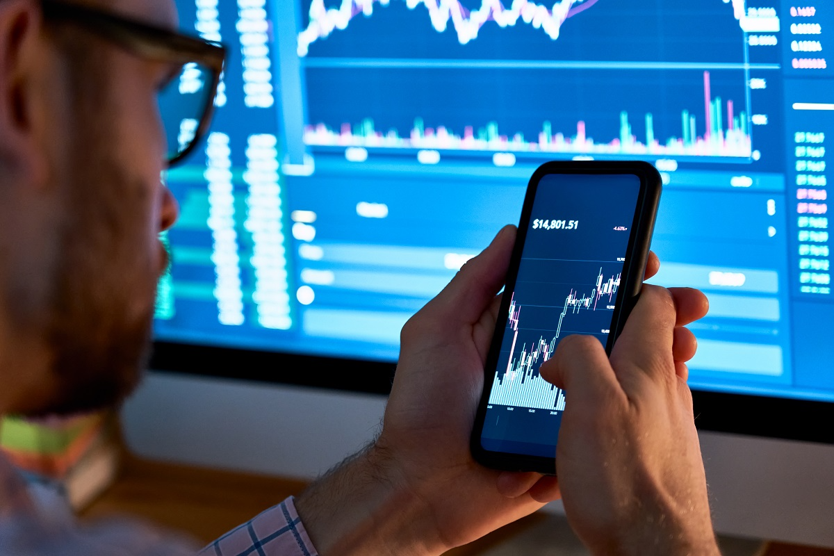 Investor reviewing stock market data on smartphone