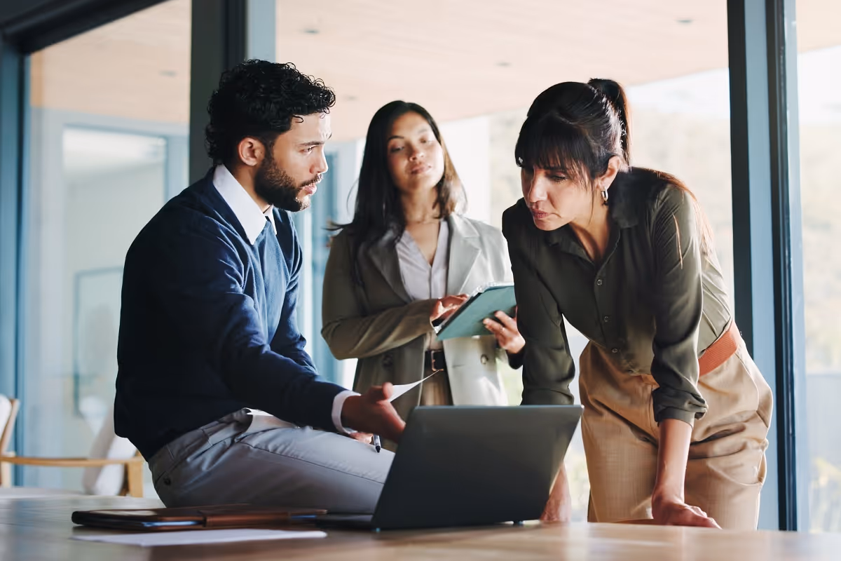 Buy-side M&A team reviewing acquisition target data and financial analysis during deal evaluation