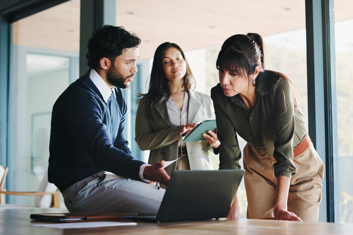 Buy-side M&A team reviewing acquisition target data and financial analysis during deal evaluation