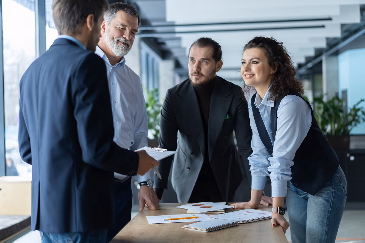 Buy-side M&A advisors and corporate executives discussing acquisition strategy, financial diligence, and deal structuring