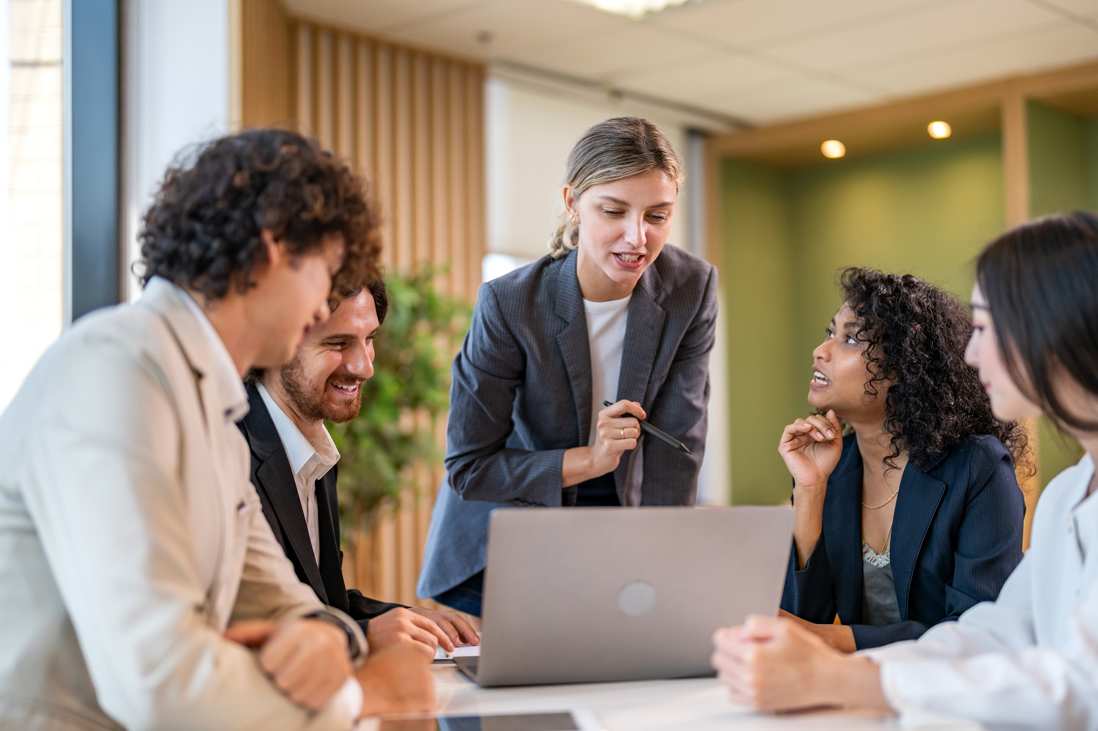 Buy-side M&A advisory team reviewing acquisition target data and valuation analysis during due diligence process