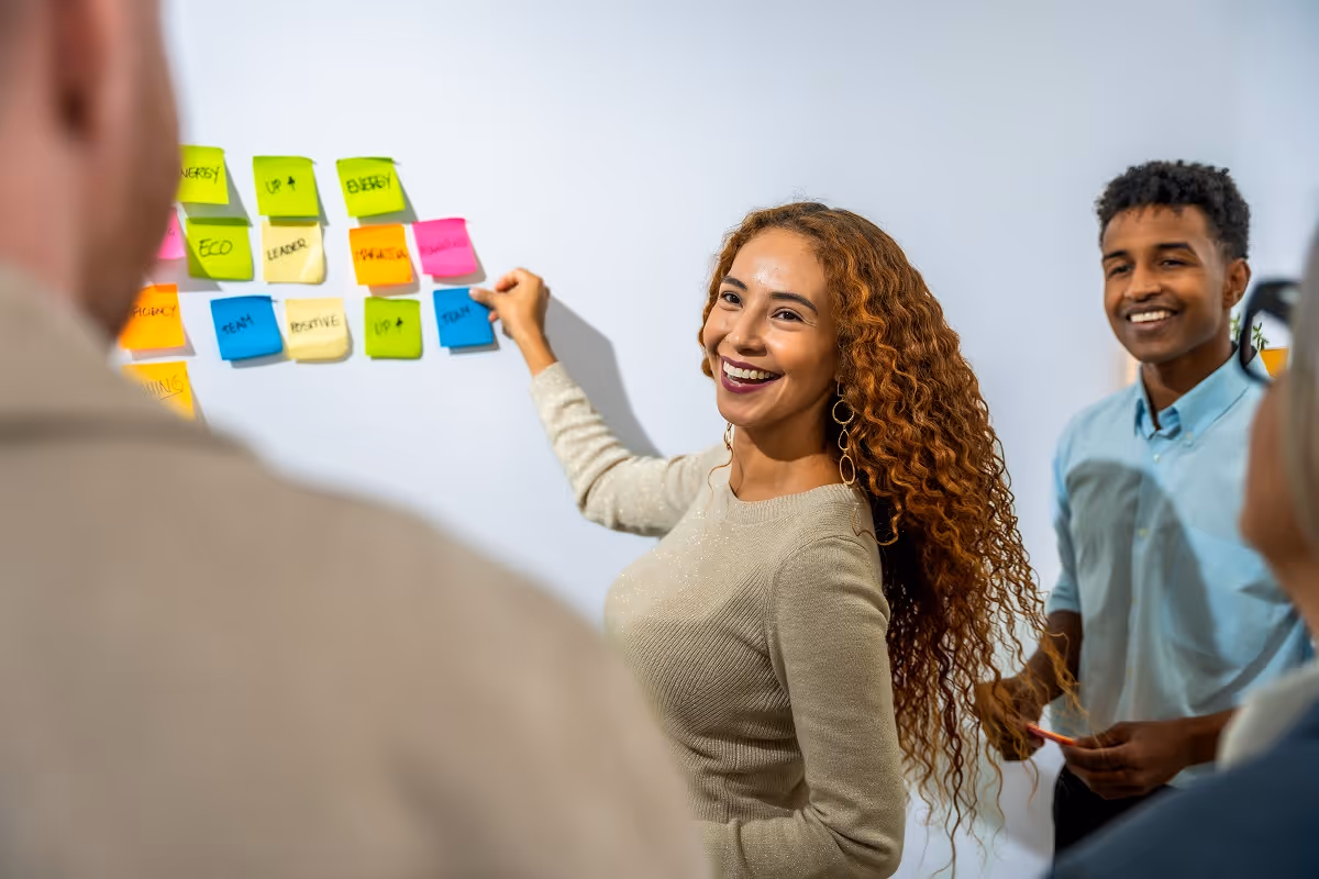 Business team planning due diligence tasks with sticky notes during an M&A buy-side diligence strategy meeting