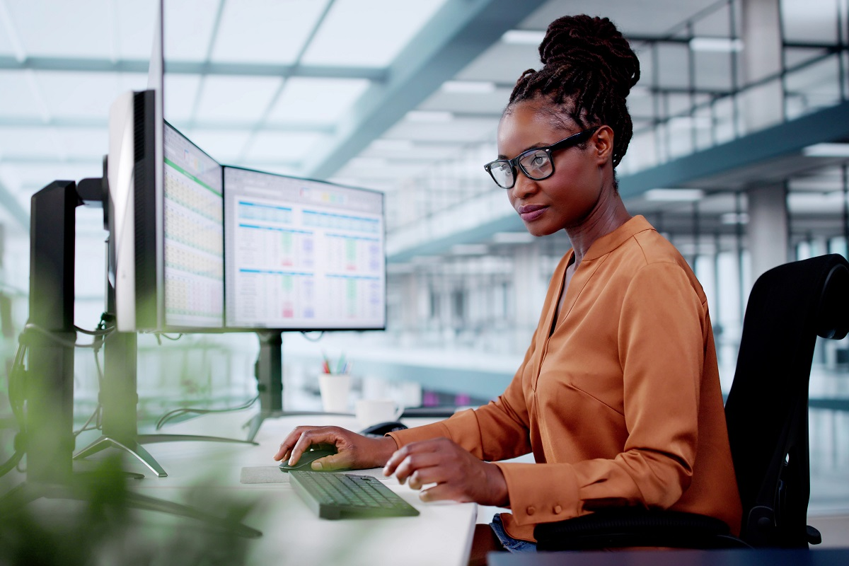 Corporate development professional managing M&A pipeline data across multiple screens