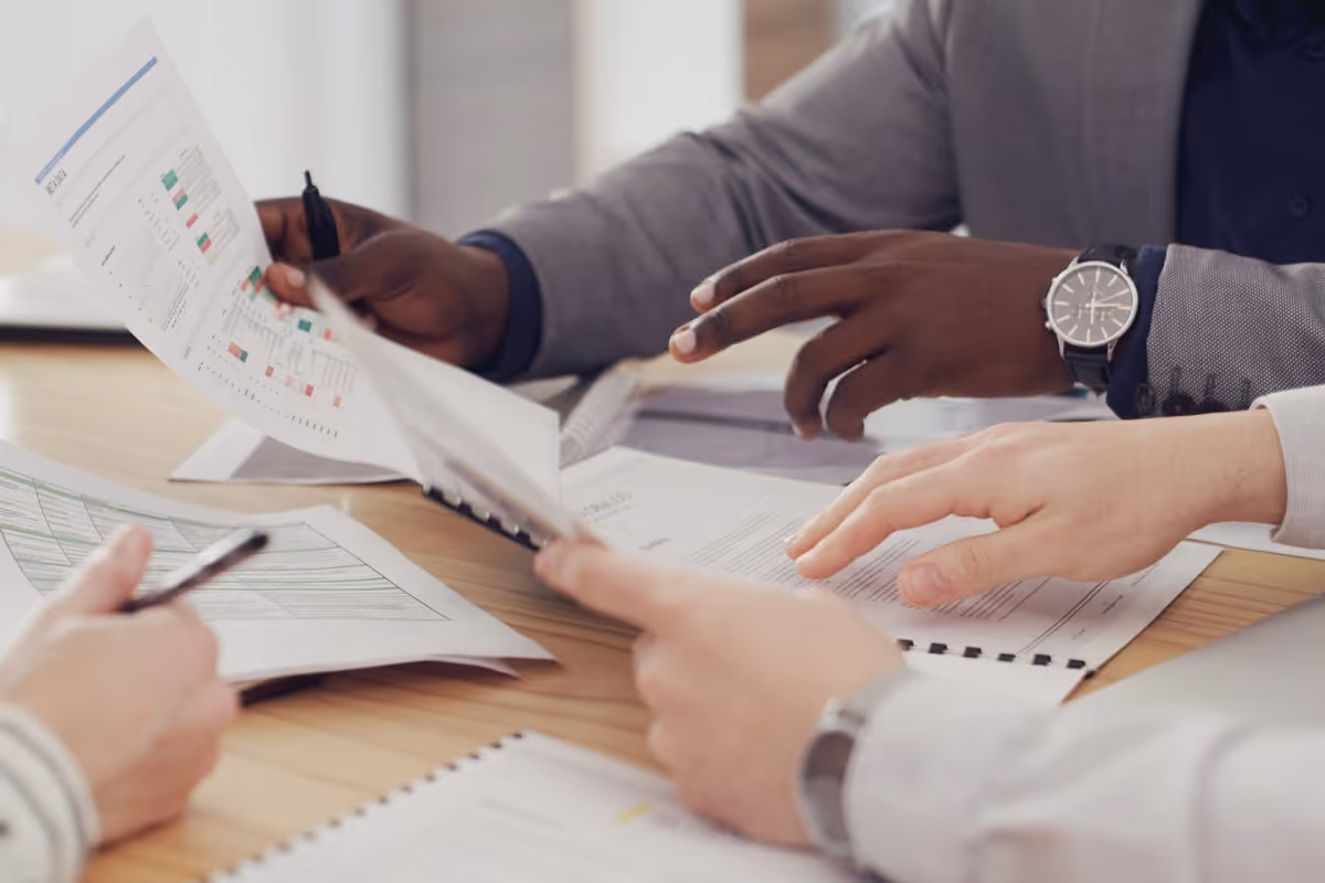 M&A team reviewing financial documents and deal data during acquisition analysis