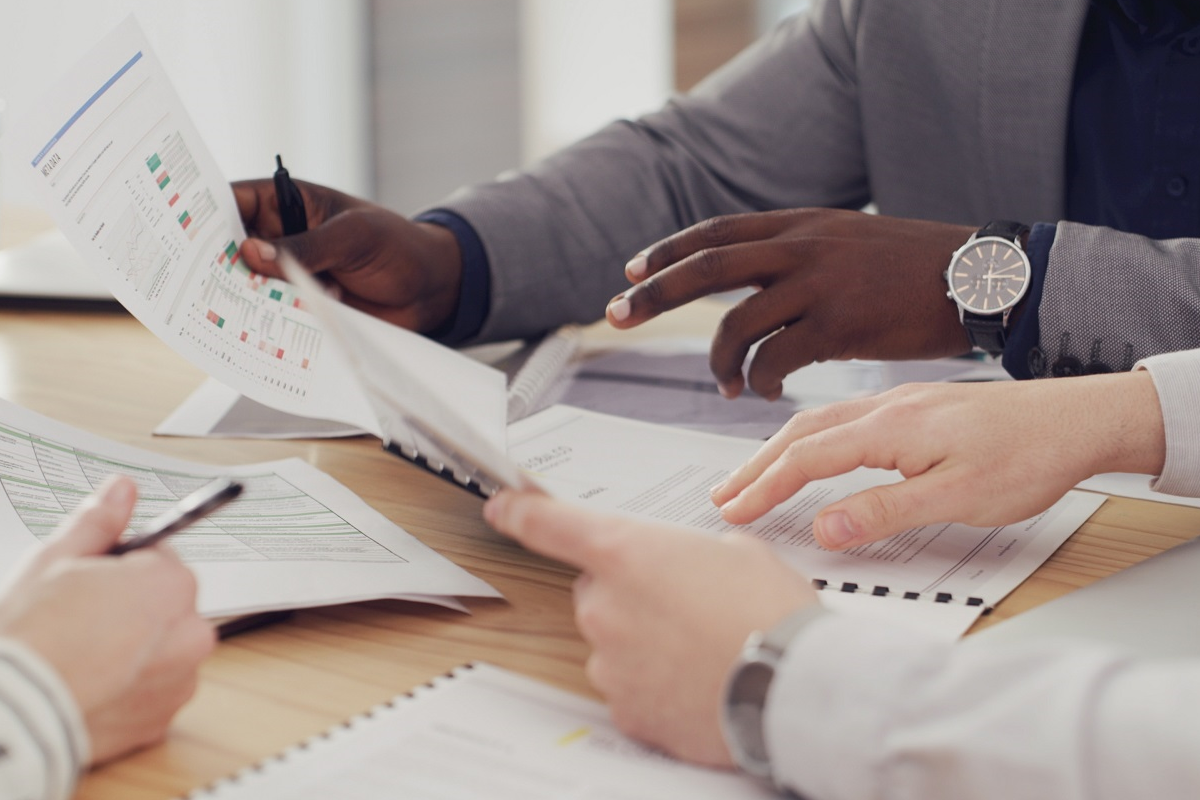 M&A team reviewing financial documents and deal data during acquisition analysis
