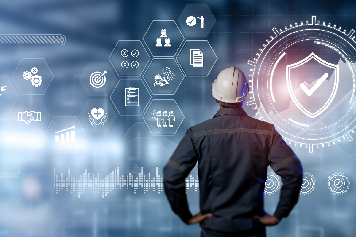 Manufacturing professional analyzing compliance, risk, and operational performance data on a digital dashboard