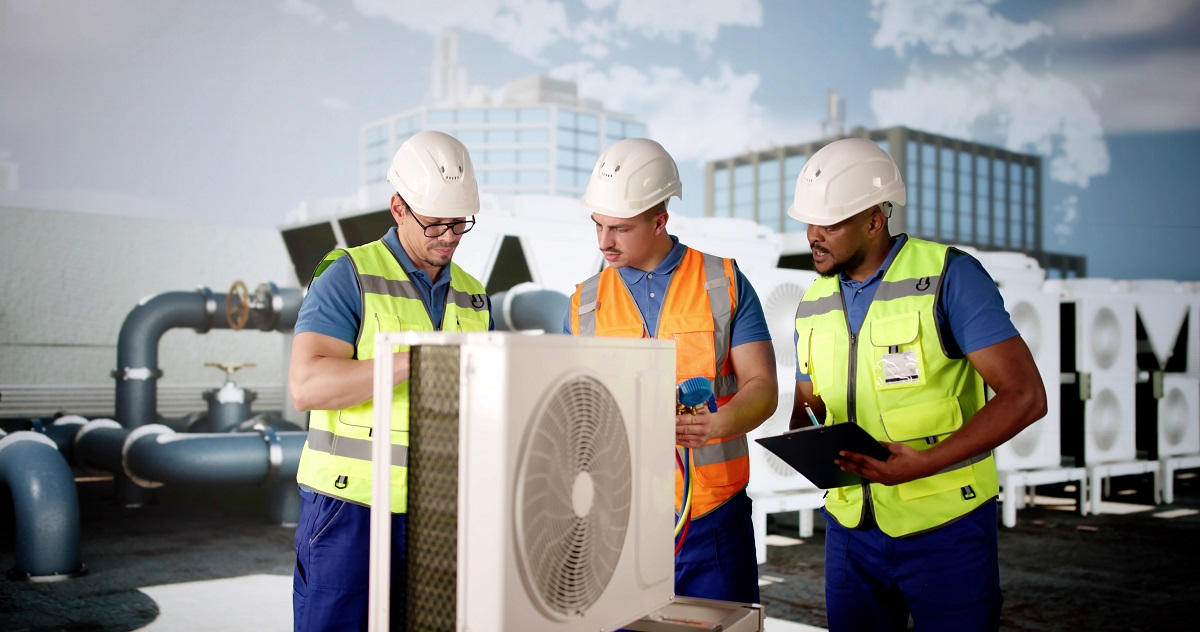Commercial HVAC technicians inspecting rooftop air conditioning equipment during a maintenance and system performance evaluation