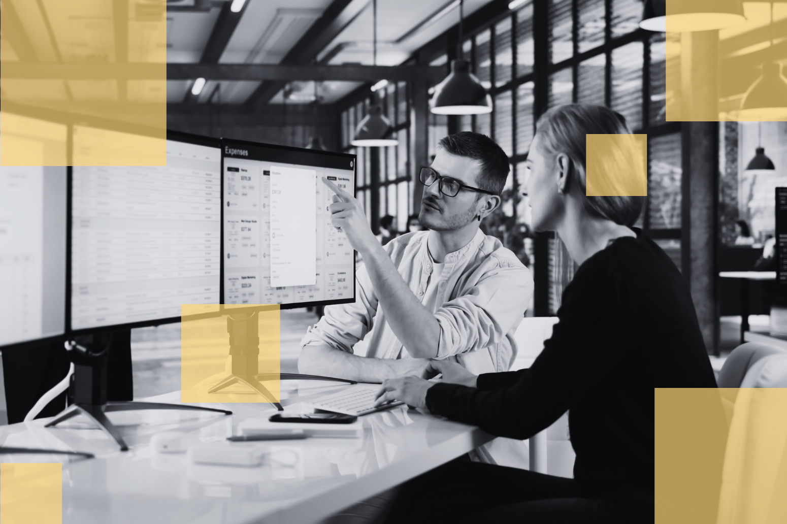 M&A finance professionals reviewing expense reports and transaction data on multiple computer monitors.