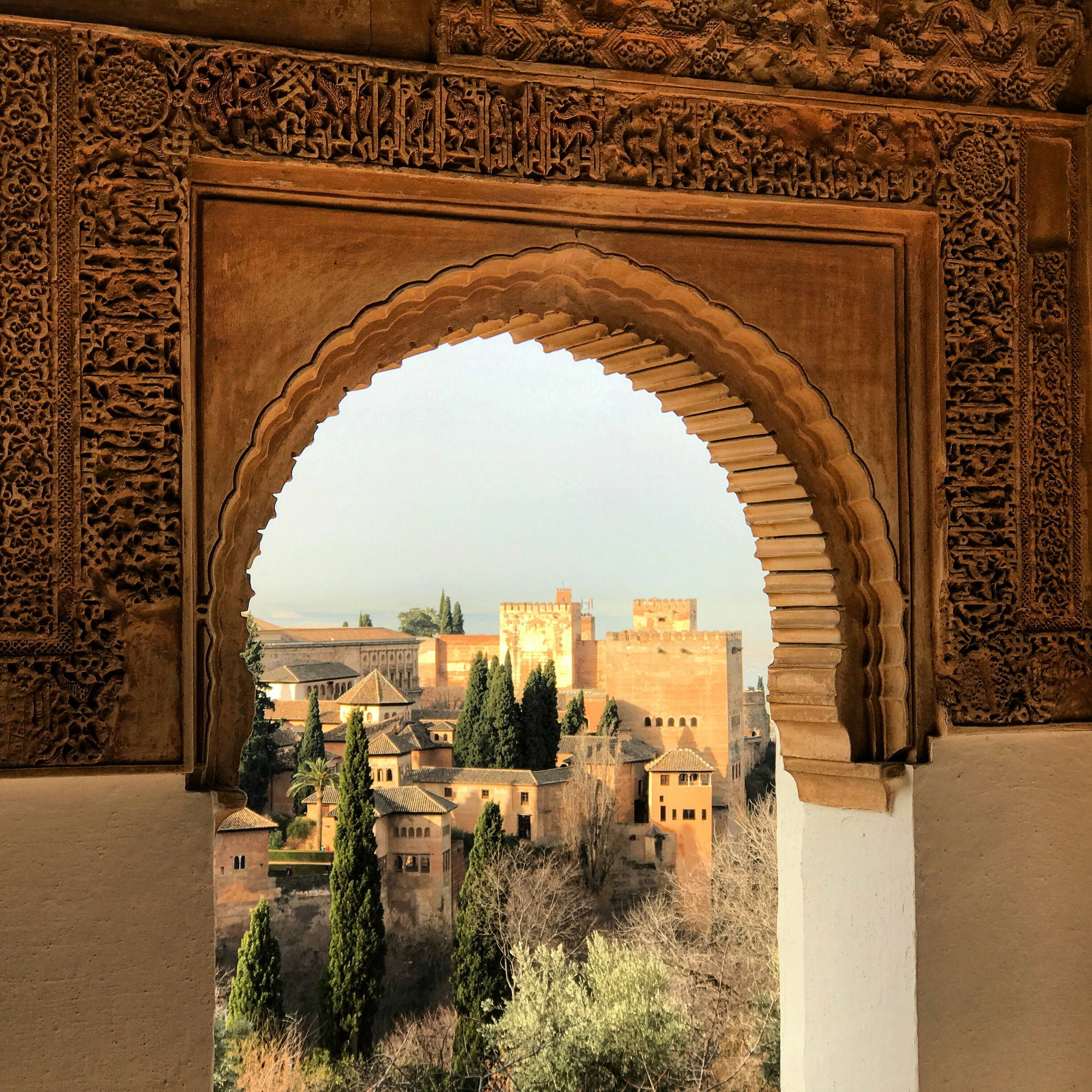 View of a beautiful portico with arches and intricate Moorish designs at the Alhambra Palace in Granada, Spain