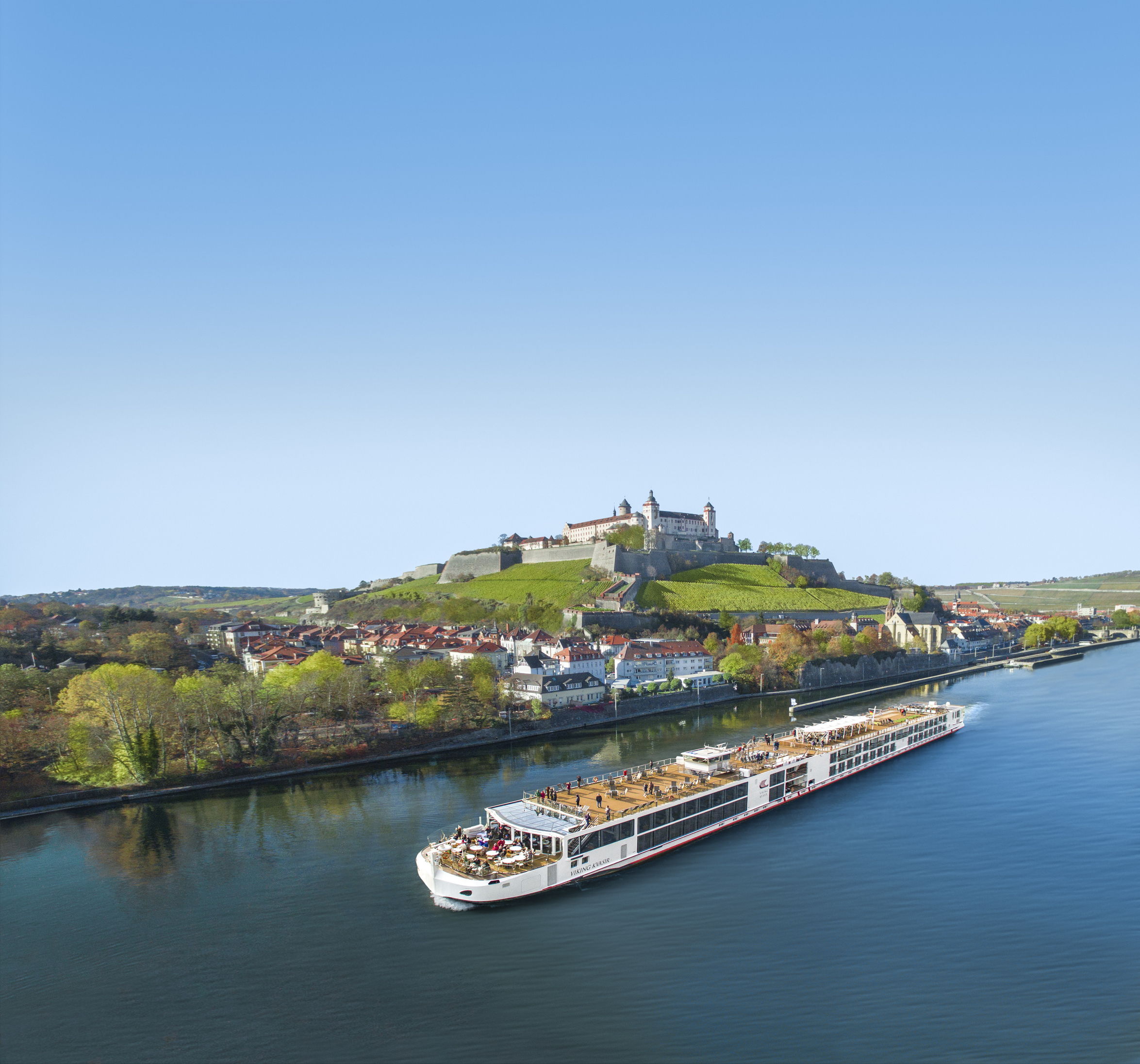 A viking Longship crossing Wurzburg, Germany with a medieval castle on top of the hill