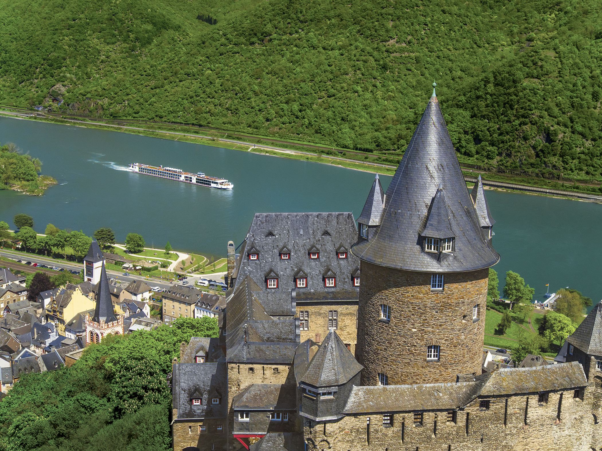 A Viking Longship cruising along the Stahleck Castle, European Rivers