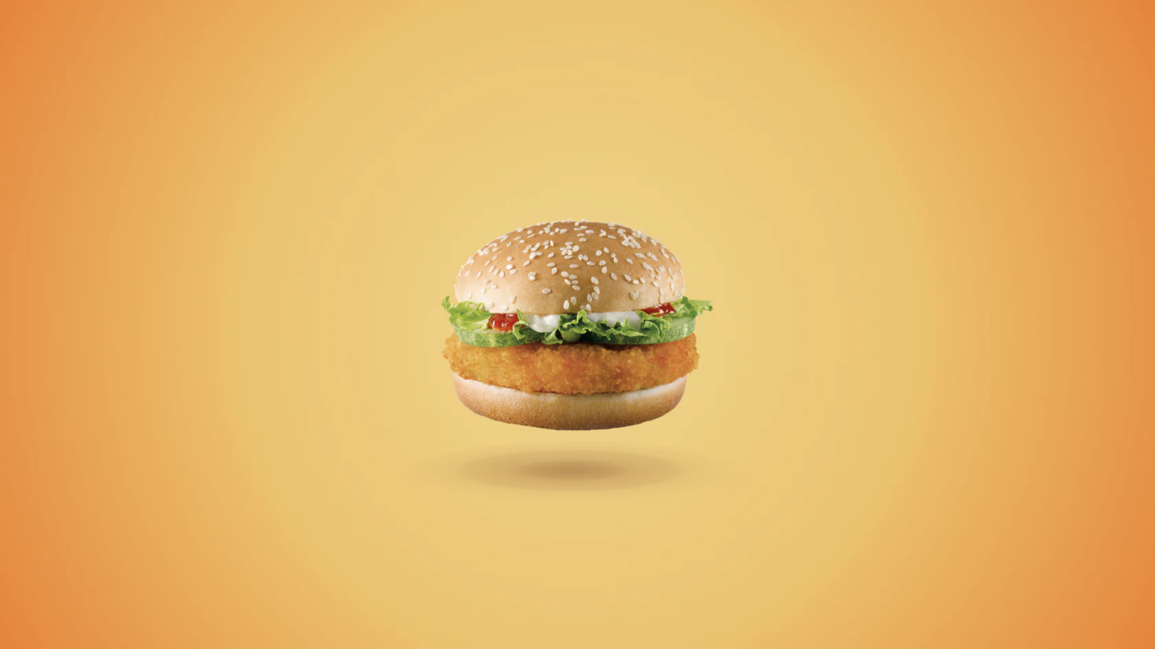 Petit hamburger sur un fond orange.