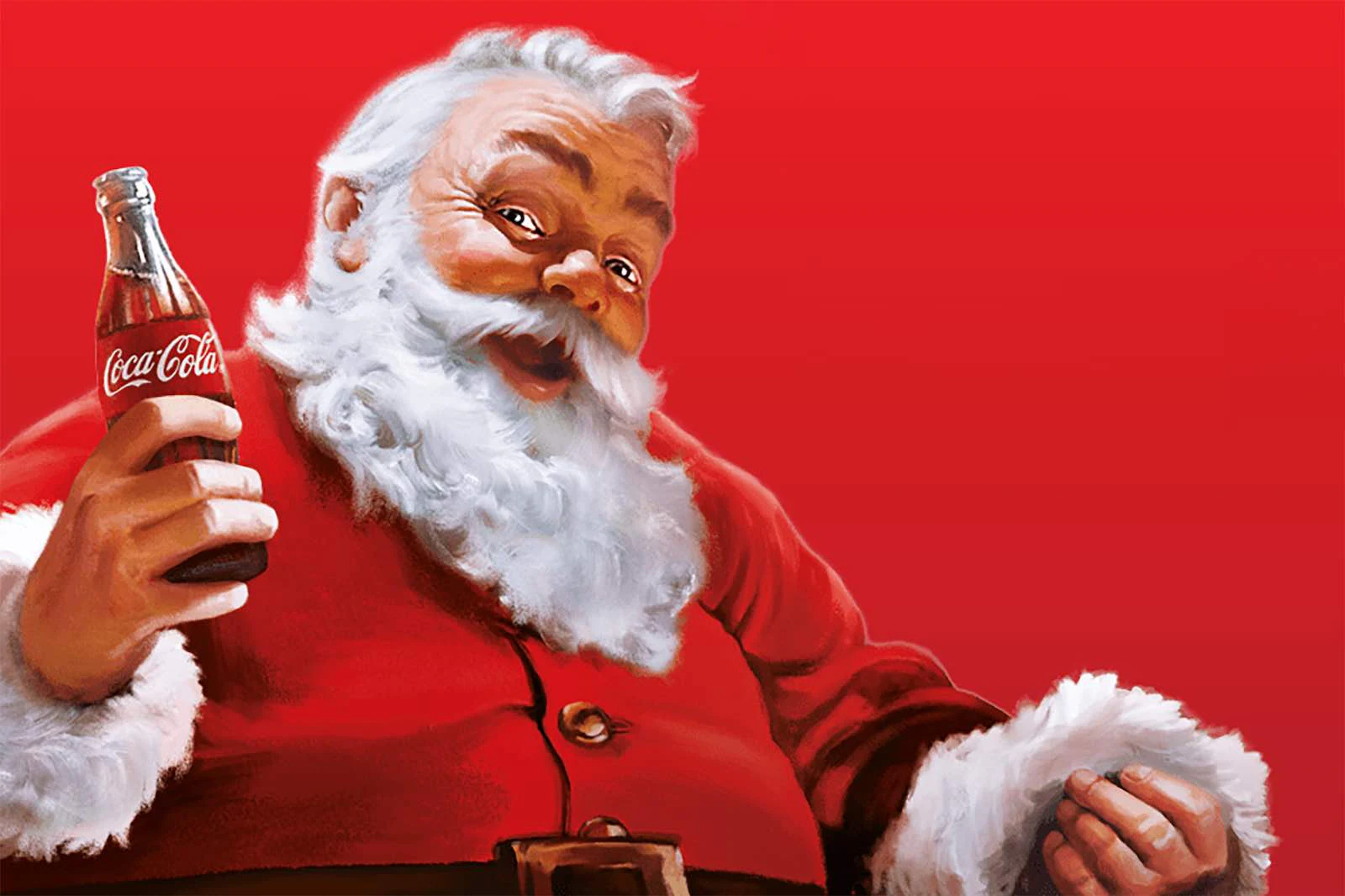 Père Noël tenant une bouteille de Coca-Cola.