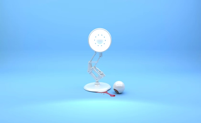 Lampe articulée regardant une ampoule cassée au sol.